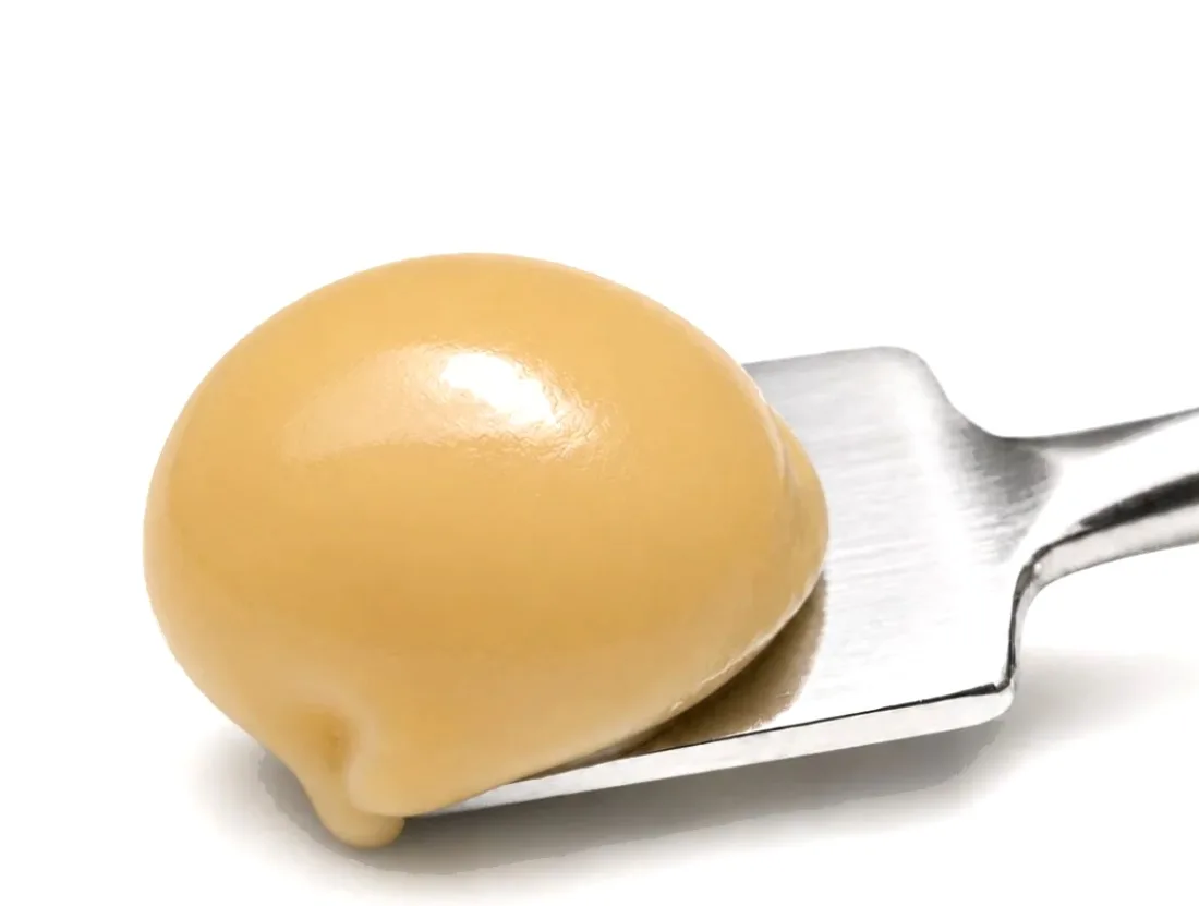 Cold-cured solventless hash on a stainless scoop — Hash Snob, New York